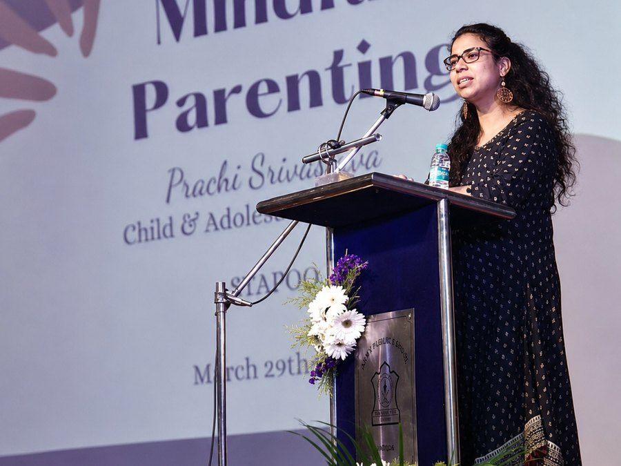 Prachi Srivastava speaking at a podium during a Mindful Parenting workshop, in front of a Stapoo-branded backdrop